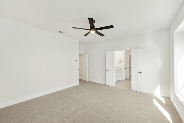 carpeted empty room featuring ceiling fan