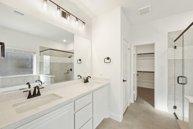 bathroom with vanity, tile patterned flooring, and a shower with door