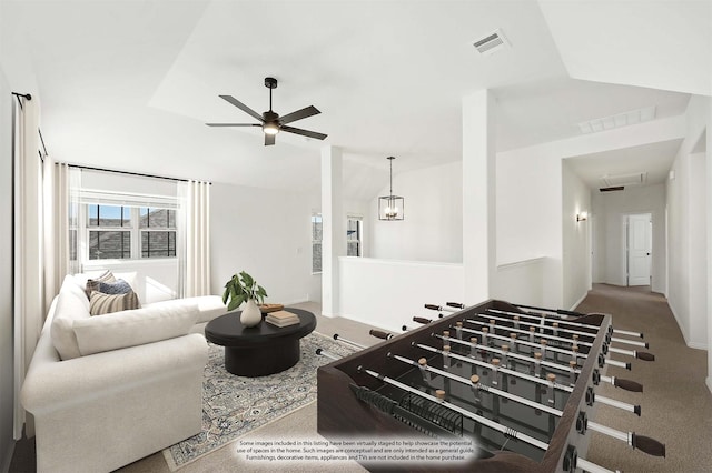 living room with ceiling fan, lofted ceiling, and carpet