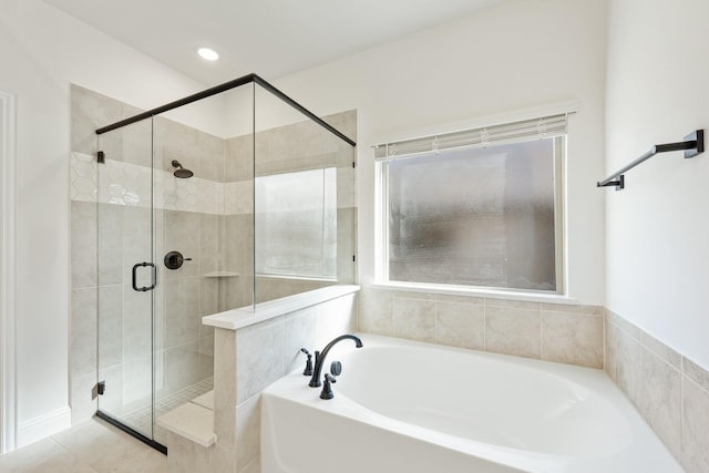 bathroom featuring shower with separate bathtub