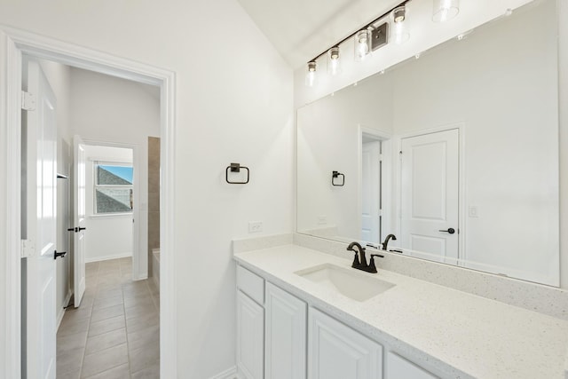 bathroom with vanity, a bathtub, tile patterned flooring, and lofted ceiling