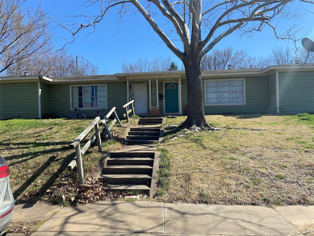 ranch-style home with a front lawn