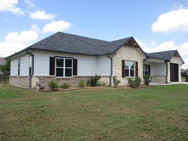 view of front of home with a garage and a front lawn