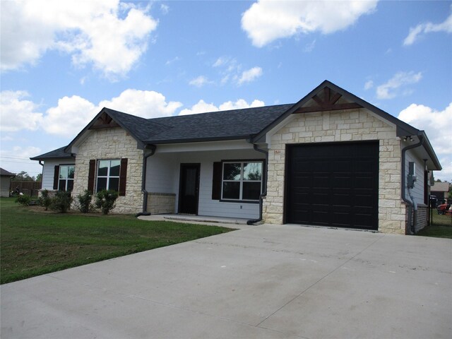 view of front facade with a garage and a front lawn