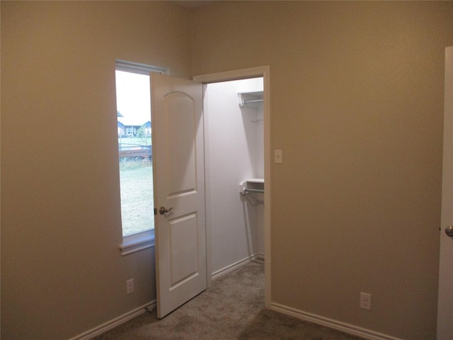 hallway with carpet flooring