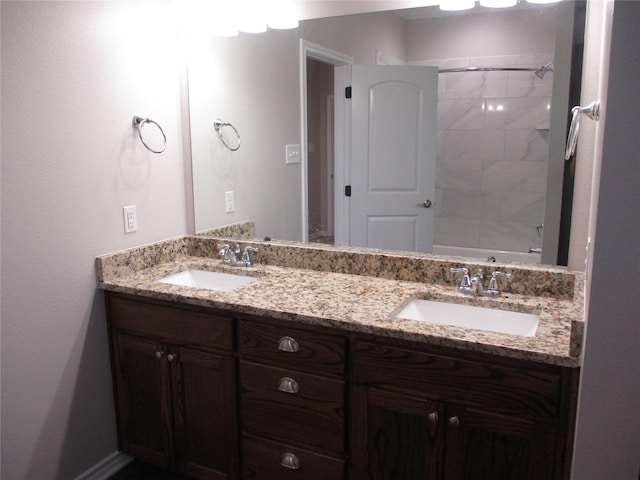 bathroom with tiled shower / bath and vanity