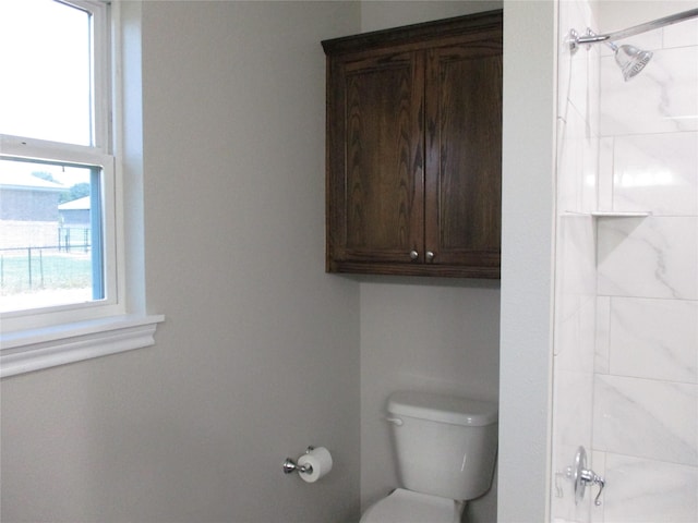 bathroom with toilet and tiled shower / bath combo