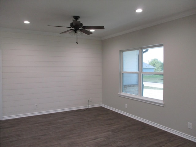 empty room featuring ceiling fan, ornamental molding, and dark hardwood / wood-style floors