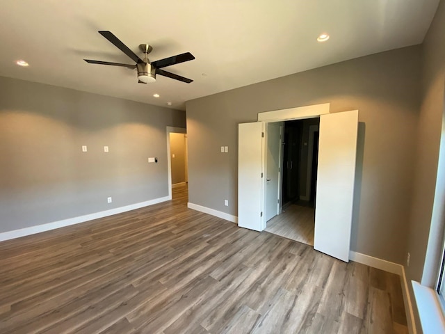 unfurnished bedroom with hardwood / wood-style flooring and ceiling fan