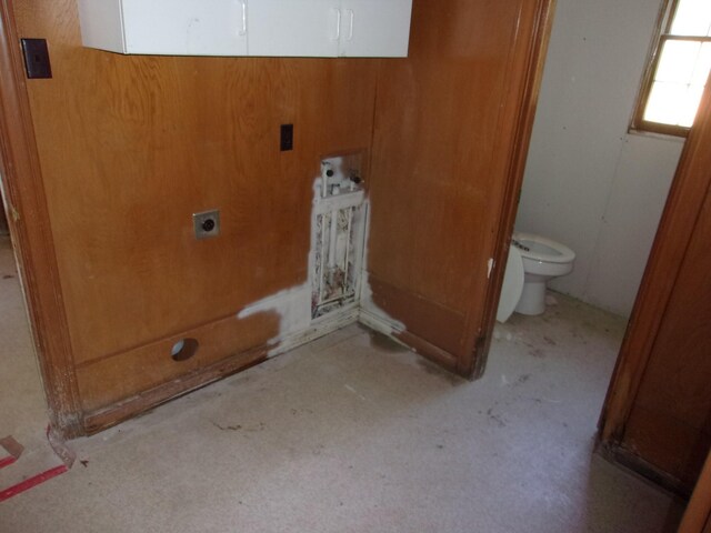 laundry room featuring hookup for an electric dryer and wooden walls