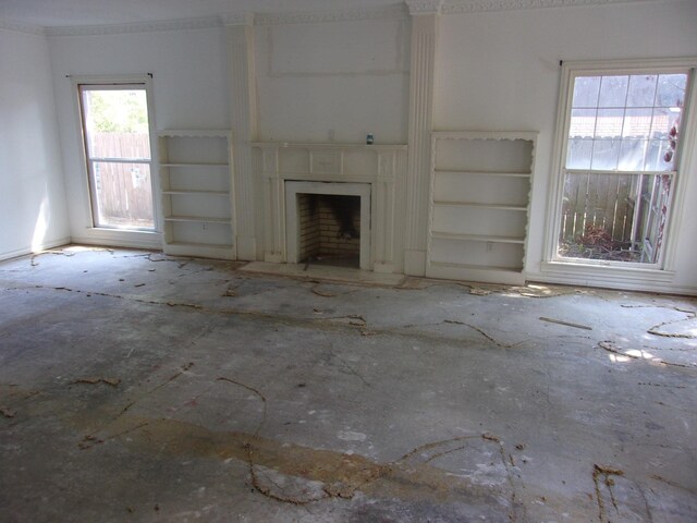 unfurnished living room with built in shelves