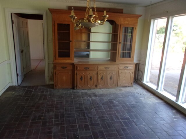 unfurnished dining area featuring a notable chandelier