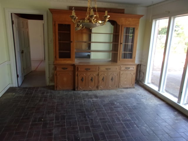 unfurnished dining area featuring an inviting chandelier