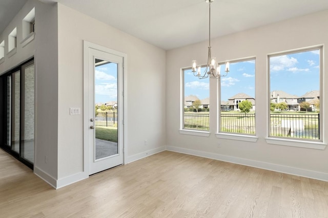 1417 Vermillion Dr, Prosper, TX 75078 - unfurnished dining area with baseboards, light wood-type flooring, and a chandelier