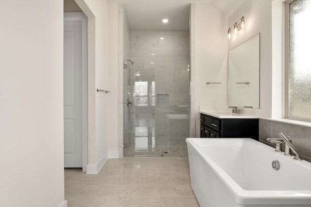 1417 Vermillion Dr, Prosper, TX 75078 - bathroom with a freestanding bath, vanity, a stall shower, and baseboards