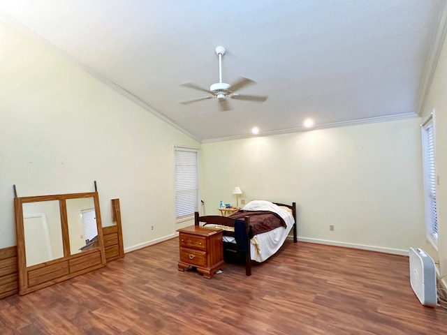 bedroom featuring dark hardwood / wood-style floors, crown molding, and ceiling fan