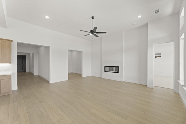 unfurnished living room with light hardwood / wood-style floors and ceiling fan