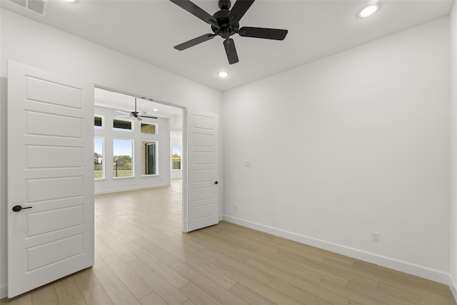 spare room featuring light hardwood / wood-style flooring and ceiling fan