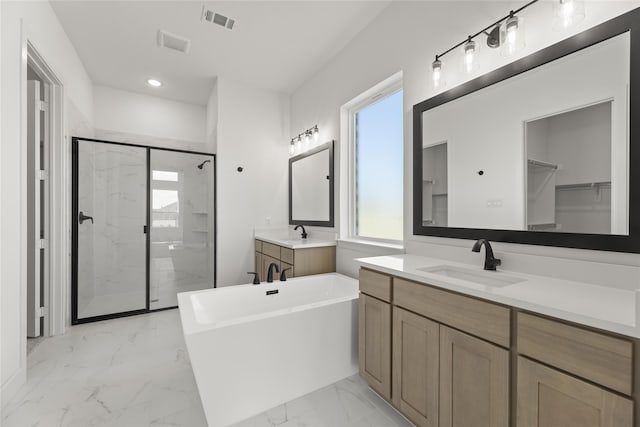 bathroom with vanity and independent shower and bath