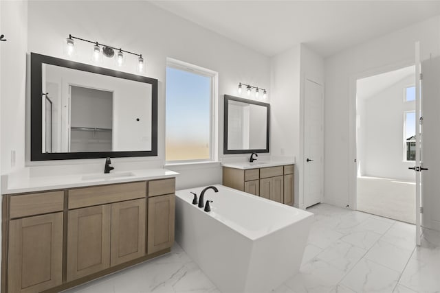 bathroom with vanity and a bath