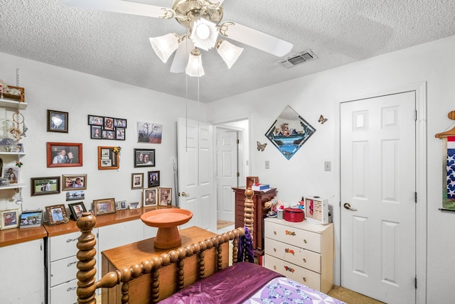 bedroom with a textured ceiling and ceiling fan