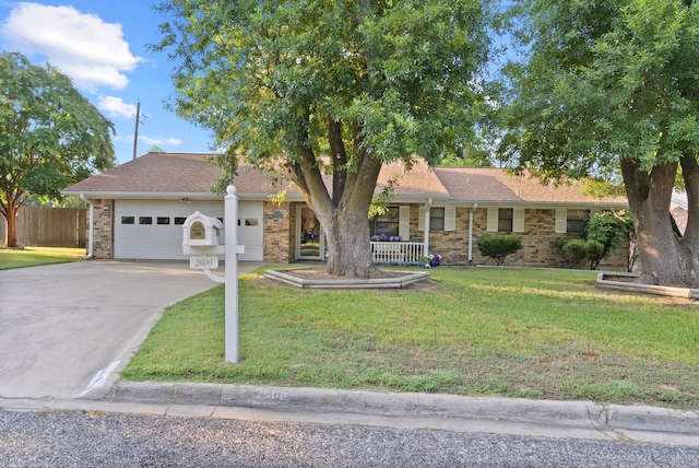 ranch-style home with a garage and a front lawn