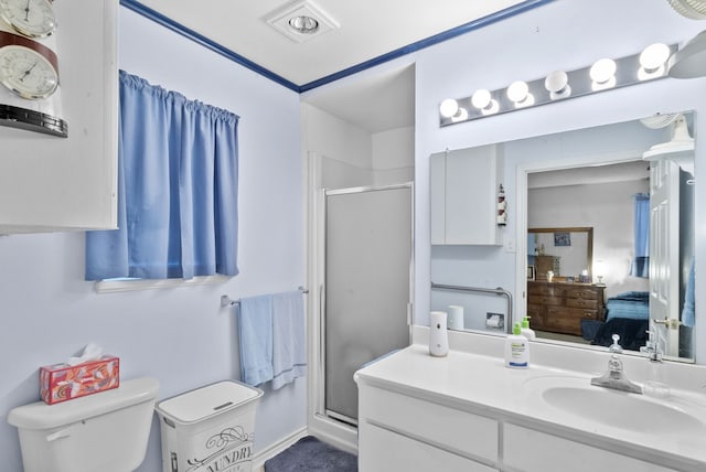 bathroom featuring vanity, a shower with shower door, and toilet