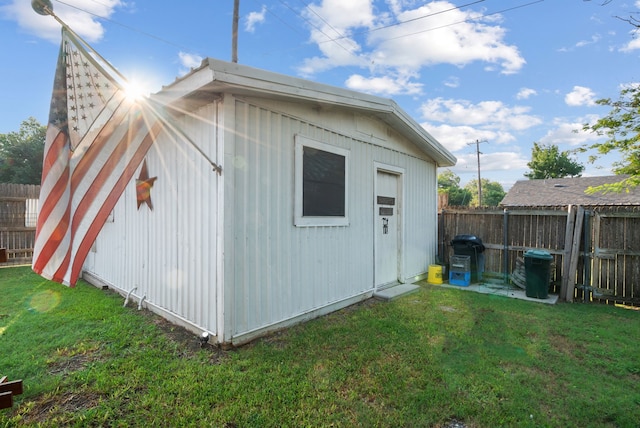 view of outbuilding with a yard