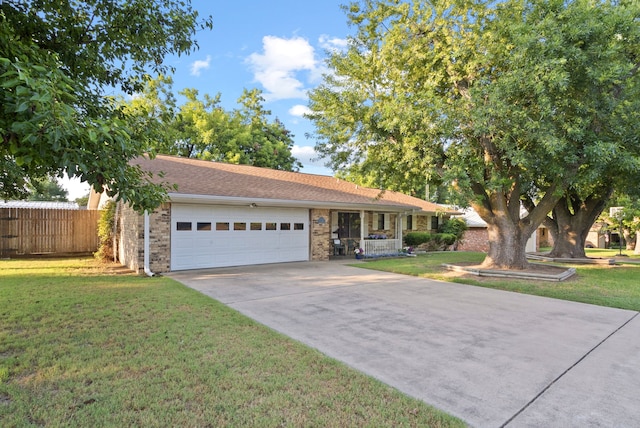 ranch-style home with a garage and a front lawn