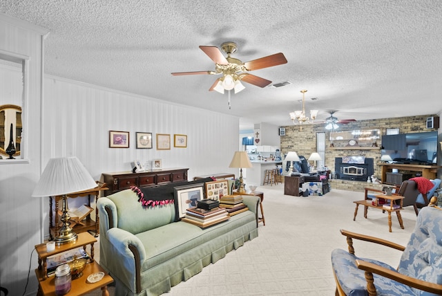 living room featuring carpet flooring, ceiling fan, a fireplace, and a textured ceiling