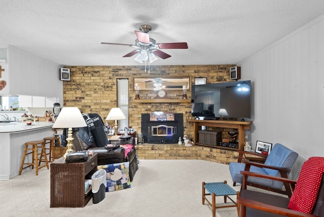 living room with ceiling fan, crown molding, and a textured ceiling