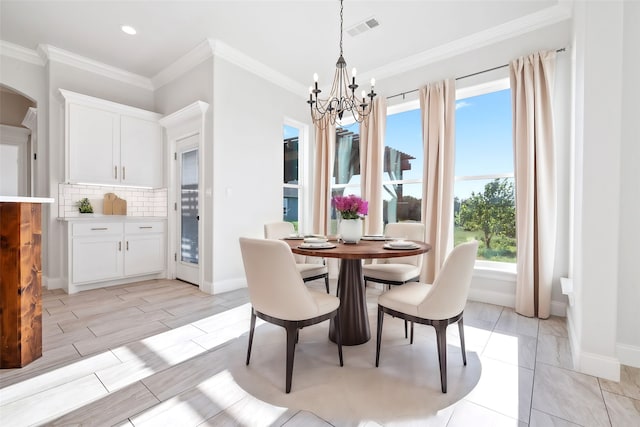 dining area featuring a notable chandelier and ornamental molding