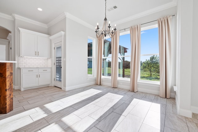 unfurnished dining area featuring crown molding, light wood-type flooring, and an inviting chandelier