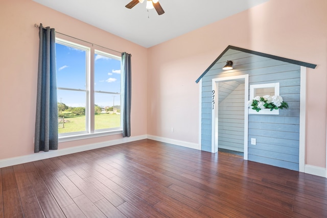 unfurnished room featuring dark hardwood / wood-style flooring and ceiling fan