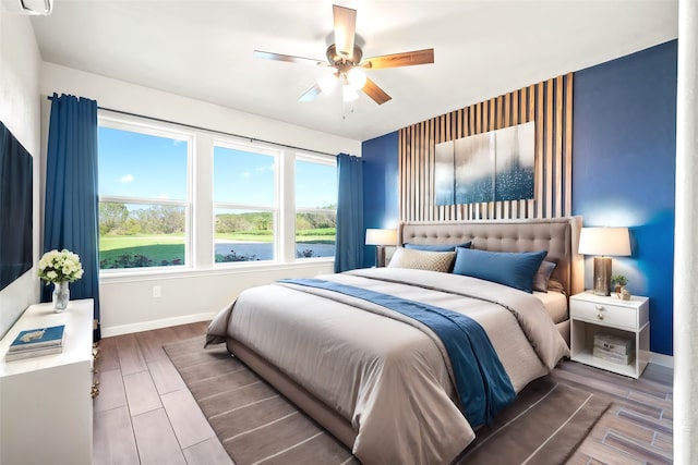 bedroom featuring ceiling fan and wood-type flooring