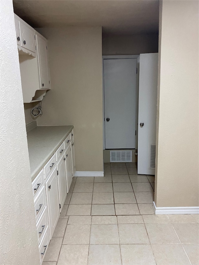 kitchen featuring white cabinetry and light tile patterned floors