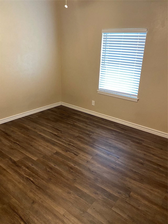 unfurnished room featuring dark hardwood / wood-style flooring