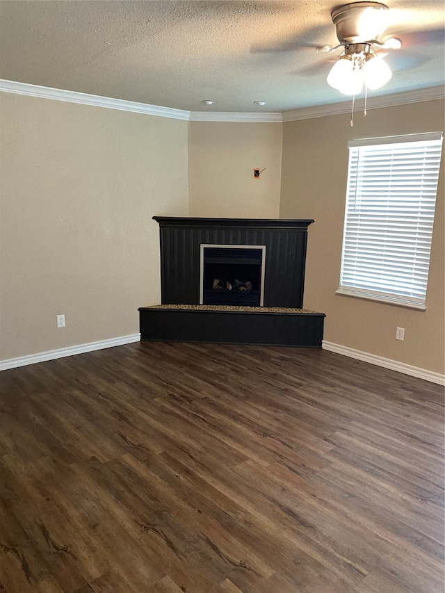 unfurnished living room featuring a textured ceiling, ceiling fan, dark hardwood / wood-style floors, and crown molding