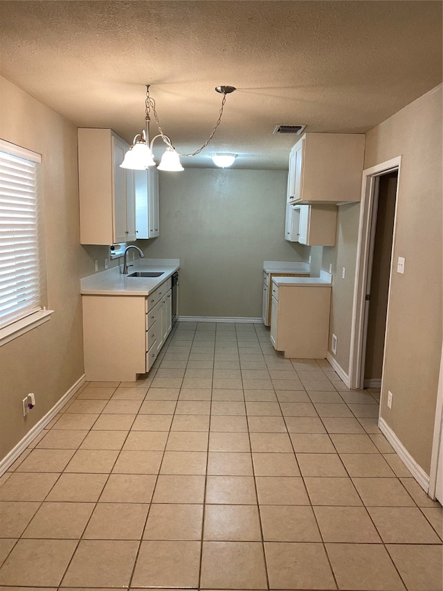 kitchen featuring light tile patterned flooring, decorative light fixtures, a notable chandelier, and sink