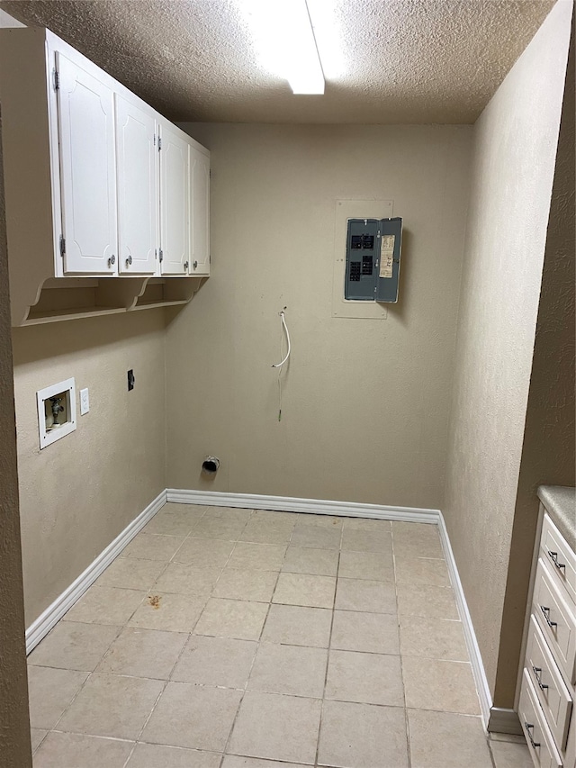 washroom featuring a textured ceiling, electric panel, hookup for a washing machine, and light tile patterned floors