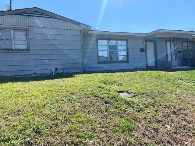 view of property exterior with a yard