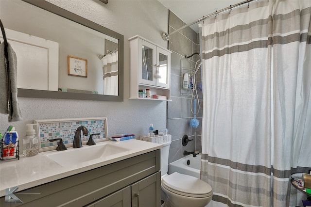 full bathroom with shower / tub combo with curtain, toilet, and vanity