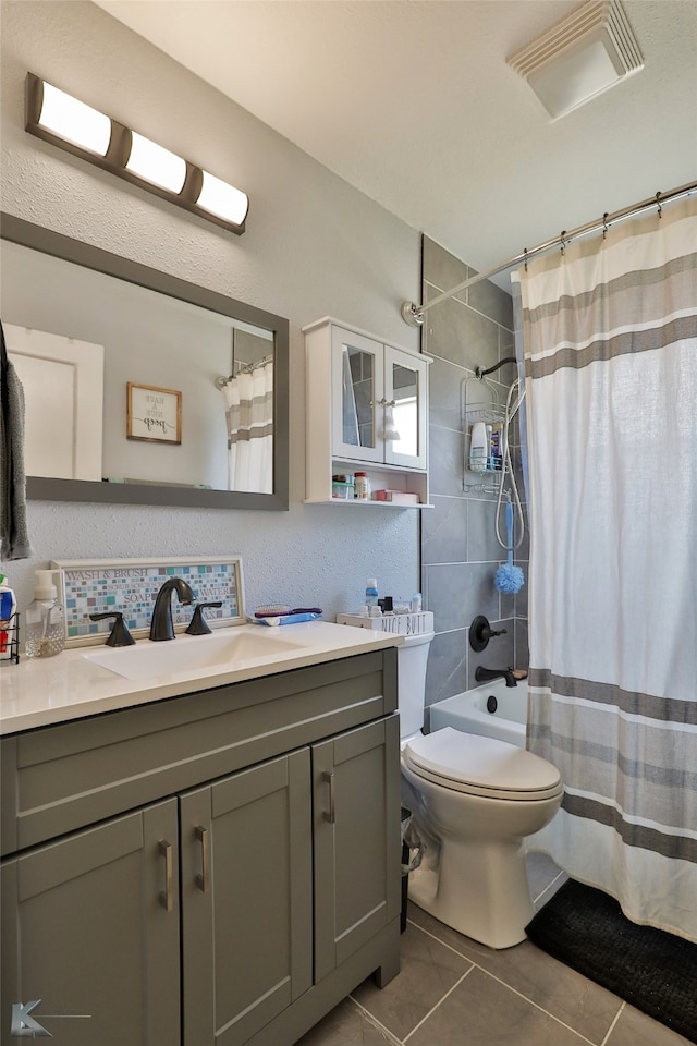 full bathroom with tile patterned flooring, toilet, vanity, and shower / bath combo with shower curtain