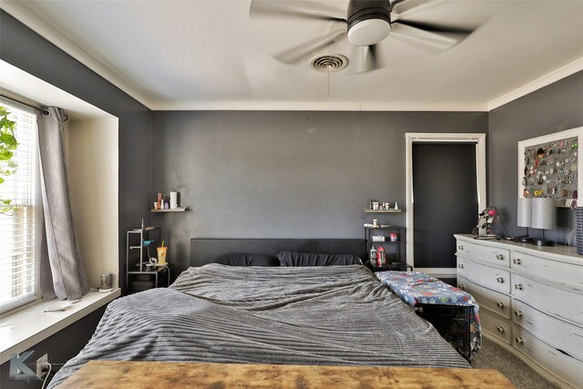 carpeted bedroom featuring ceiling fan and multiple windows