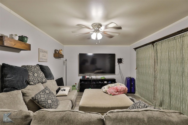 living room featuring crown molding, wood finished floors, and ceiling fan