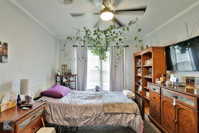 carpeted bedroom with ceiling fan and crown molding