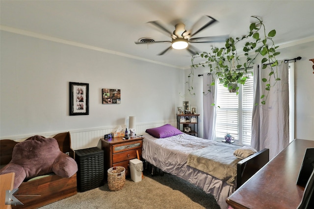 carpeted bedroom featuring ceiling fan and crown molding