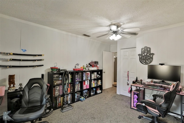 carpeted office with ceiling fan and a textured ceiling