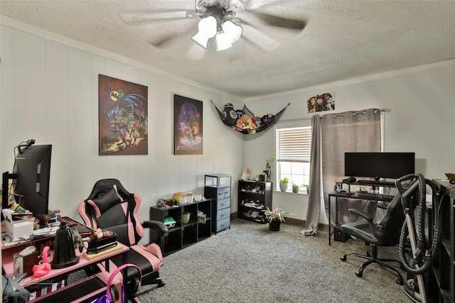 carpeted home office with a textured ceiling, ceiling fan, and ornamental molding