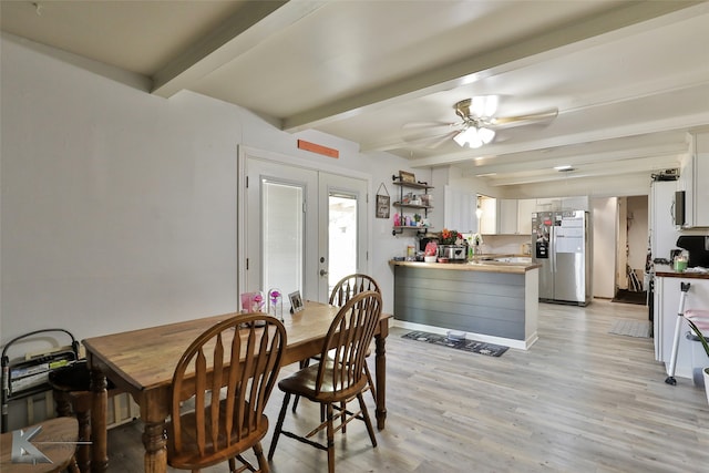 dining space featuring ceiling fan, beam ceiling, french doors, and light wood-type flooring